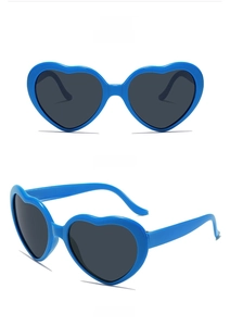 Macro detail of heart-shaped sunglasses in royal blue with dark grey tinted lenses