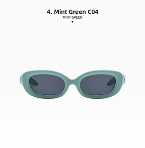 Detail view of oval mint green sunglasses C04 with thick frames and dark tinted lenses