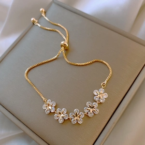 Elegant gold-plated flower bracelet with star-shaped zircon inlays on luxury jewelry box