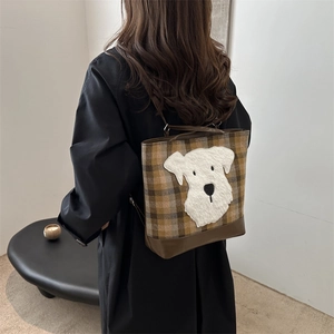 Brown plaid tote backpack featuring 3D dog embroidery and leather base on model