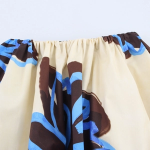 Detail of elastic waistband and floral pattern on lightweight A-line maxi skirt