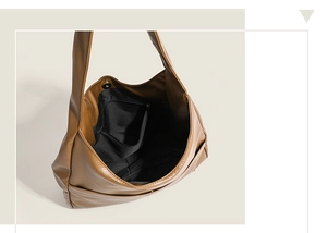 Interior view of brown leather tote bag showing spacious black lining and zipper pocket