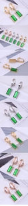 Detail view of rectangular emerald cut green gemstone earrings in gold and silver finish