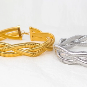 Detail of twisted woven necklaces in gold and silver finish with lobster clasp