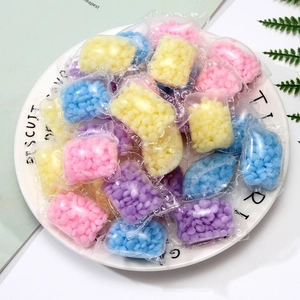 Mix scent laundry fragrance booster beads in portable pouches on a white ceramic plate