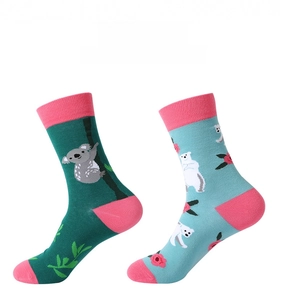 Close-up of animal mid-calf socks with koala and polar bear patterns in pink contrast