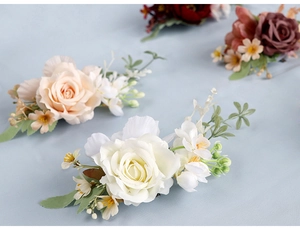 Macro view of artificial rose corsage with silk petals and delicate green leaves