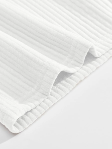 Close-up of white corduroy fabric texture and premium stitching on men's casual shorts