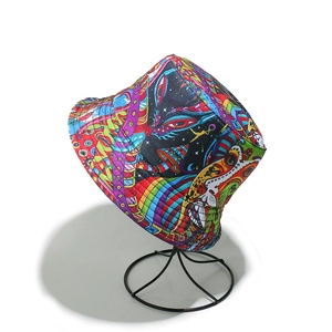 Detail of psychedelic graffiti pattern bucket hat on a black metal display stand