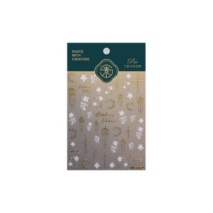 Golden and white floral nail stickers with moon and cross motifs on green packaging