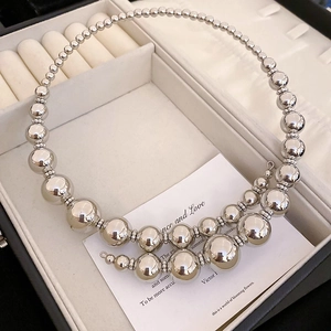 Detail of silver graduated metal bead necklace in a premium velvet jewelry gift box