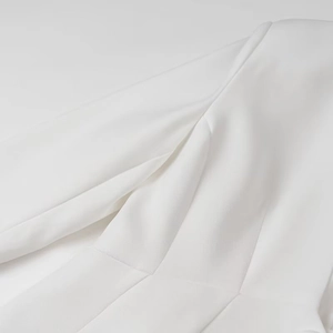 Chic white two-piece suit set featuring padded shoulder blazer and structured waist
