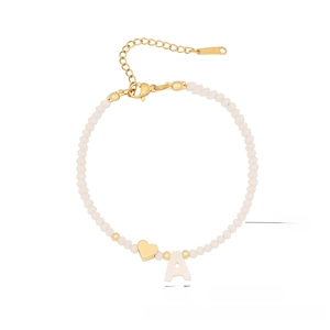 Detail of crystal beaded bracelet with shell letter A and golden heart pendant