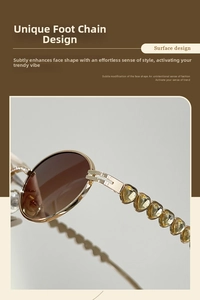Detail of metal sunglasses featuring yellow heart-shaped crystals on the temple arm