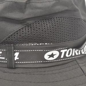 Detailed close-up of breathable mesh panel and nylon webbing on a black outdoor sun hat