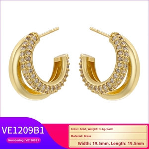 Macro detail of gold-plated double-layer C-shaped earrings with micro-set cubic zirconia