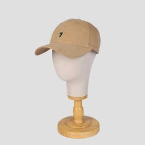 Khaki cotton baseball cap with green number 7 embroidery on a white mannequin head