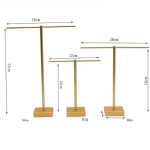 Three gold T-bar metal jewelry stands for earrings with dimension labels on white background