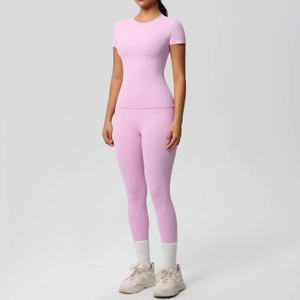 Front view of light pink yoga set featuring short sleeve top and high waist leggings