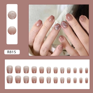 Nude pink gradient press-on nails with 3D butterfly art and shimmer accents
