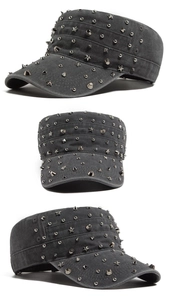Close-up of distressed dark grey army cap featuring silver punk metal rivets and stars