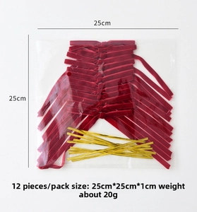 Close-up of 12 red velvet Christmas bows with gold twist ties in transparent packaging