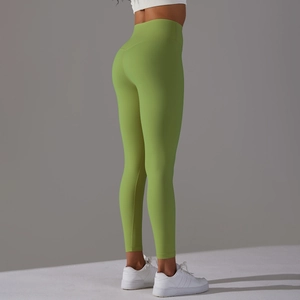 Macro side view of high-waist green yoga leggings showing butt-lifting and slim-fit design