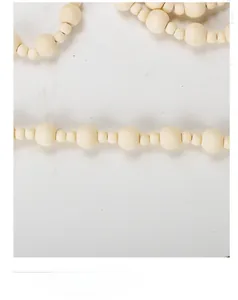 Macro view of natural wood beads in varying sizes on a Christmas hanging garland