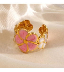 Macro detail of the adjustable gold flower ring with pink and white enamel petals