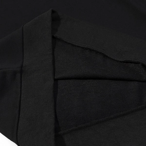 Detail view of black hoodie ribbed cuffs and high-quality cotton terry fabric texture