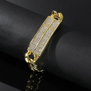 Luxurious gold-plated Cuban chain bracelet with full pavé crystals on a black background