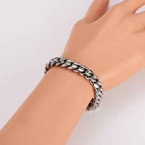Silver stainless steel Cuban chain bracelet displayed on an arm model with a polished finish