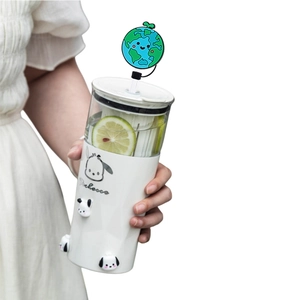 Reusable earth-shaped silicone straw cap on a white tumbler with cute cartoon patterns