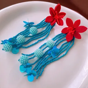 Bohemian floral tassel earrings with red felt flowers and turquoise seed bead fringe