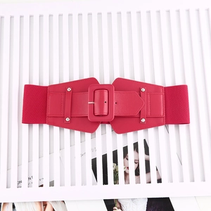 Macro shot of red elastic wide waist belt with square buckle and silver metal rivets