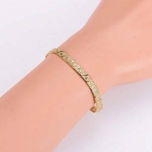 Golden flat snake chain necklace with textured finish shown on an arm mannequin