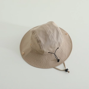 Detail of khaki outdoor sun hat featuring metal vents and adjustable windproof rope