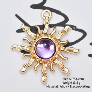 Detail showing a 2.7x3.0cm gold alloy sun charm with a central purple gemstone