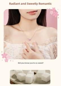 Detail of a 925 sterling silver necklace featuring a pink heart pendant with micro-diamonds
