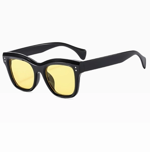 Detail of retro square black frames with yellow lenses and silver metal rivets
