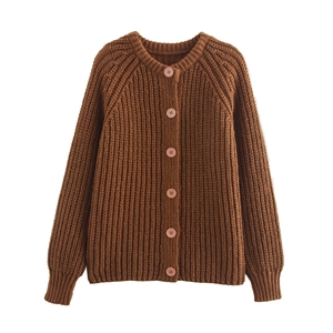 Detail of chunky knit dark brown cardigan showing thick texture and pink buttons