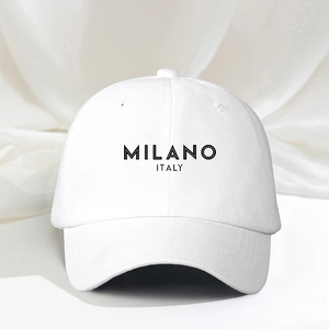 Close-up of MILANO ITALY printed text on white cotton baseball cap with twill texture