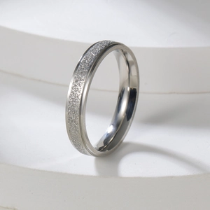Detail of 2mm silver stainless steel ring with frosted finish and polished edges