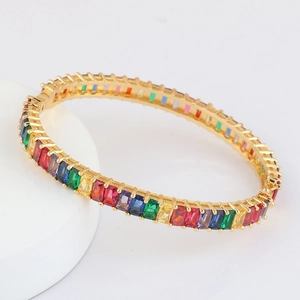 Close-up of rainbow zirconia stones on a gold-plated bohemian cuff bracelet