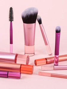 Detailed view of pink gradient crystal handles and soft synthetic bristles of makeup brushes