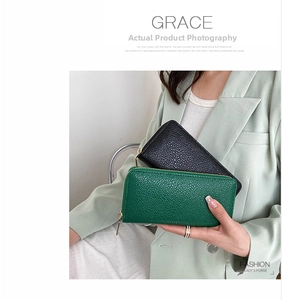 Detailed view of long zip-around wallets in dark green and black litchi texture PU leather
