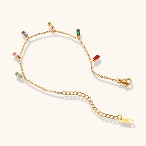 Detail of 18K gold bracelet with rectangular colorful zircon gemstones and lobster clasp