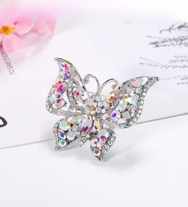 Macro detail of silver butterfly brooch with multicolored rhinestones and intricate wings