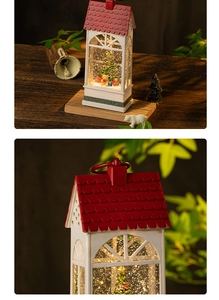 Detail of Christmas lantern snow globe with glowing light, tree and festive miniatures