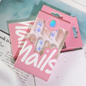 Press-on nails set featuring long pointed tips with blue bows, pearls and lace patterns